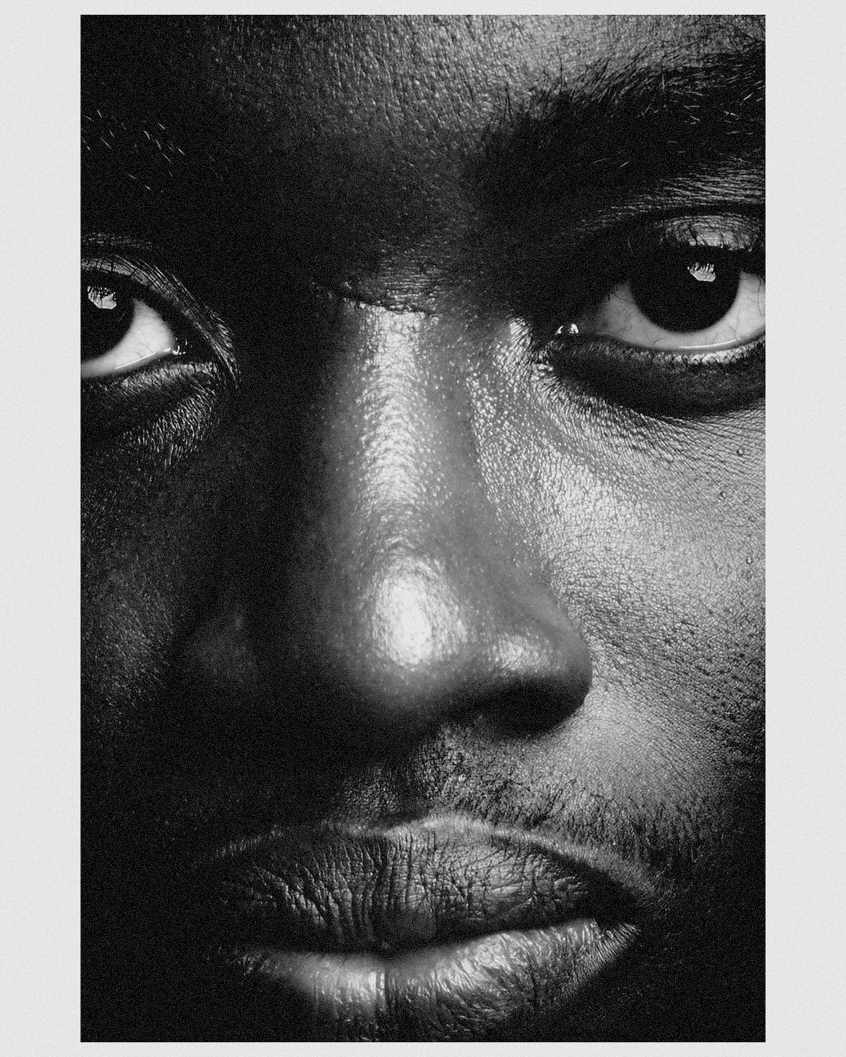 Black-and-white extreme close-up of a man's eyes, nose and mouth