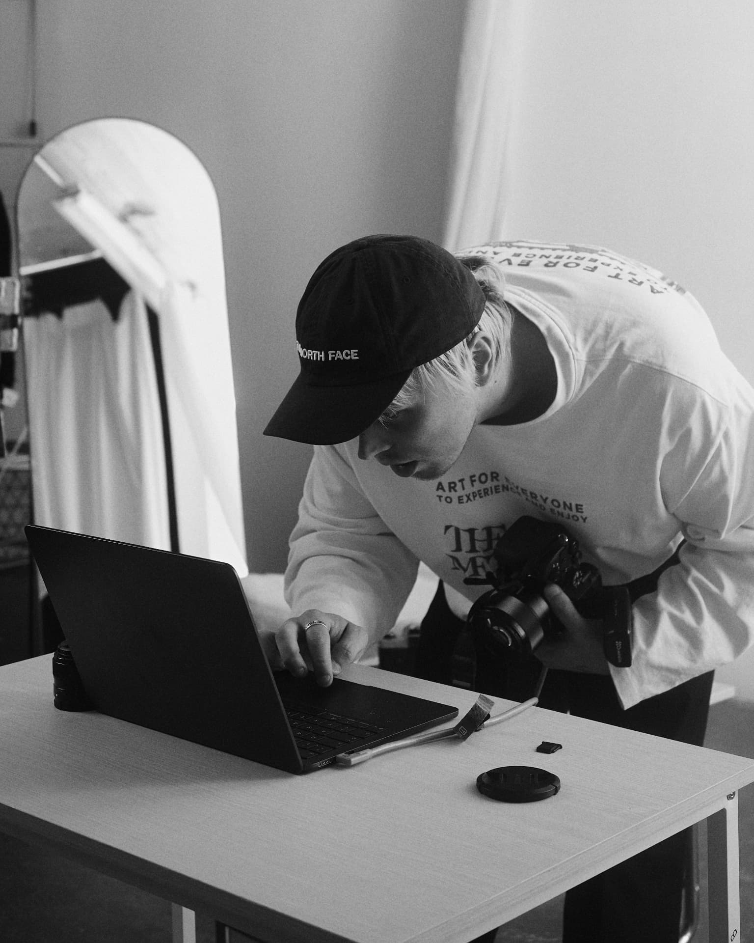 Dmytro Huk checking frames on a laptop during a shoot